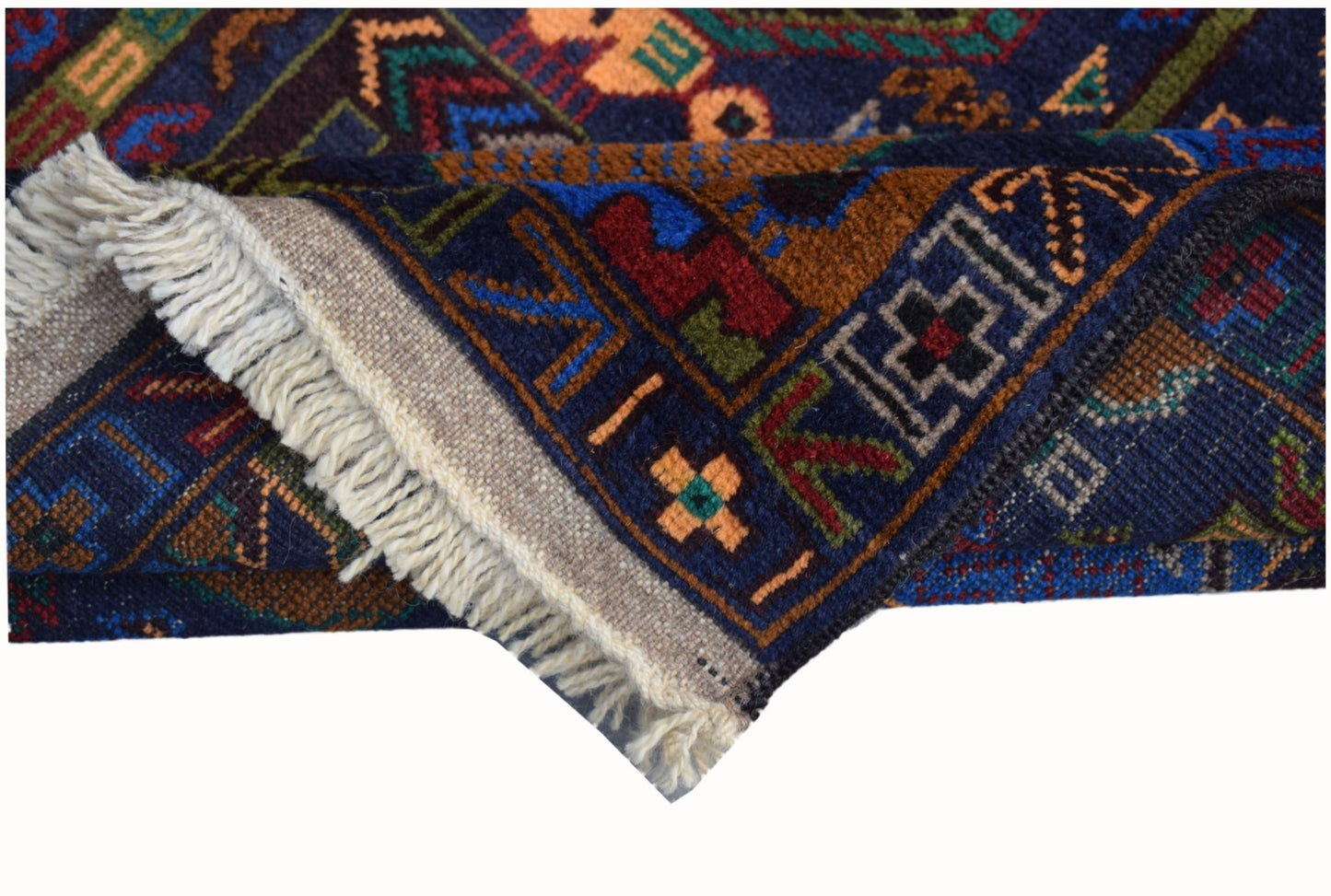 A handmade Afghan wool runner featuring a dark blue background with intricate hunting scene motifs.
