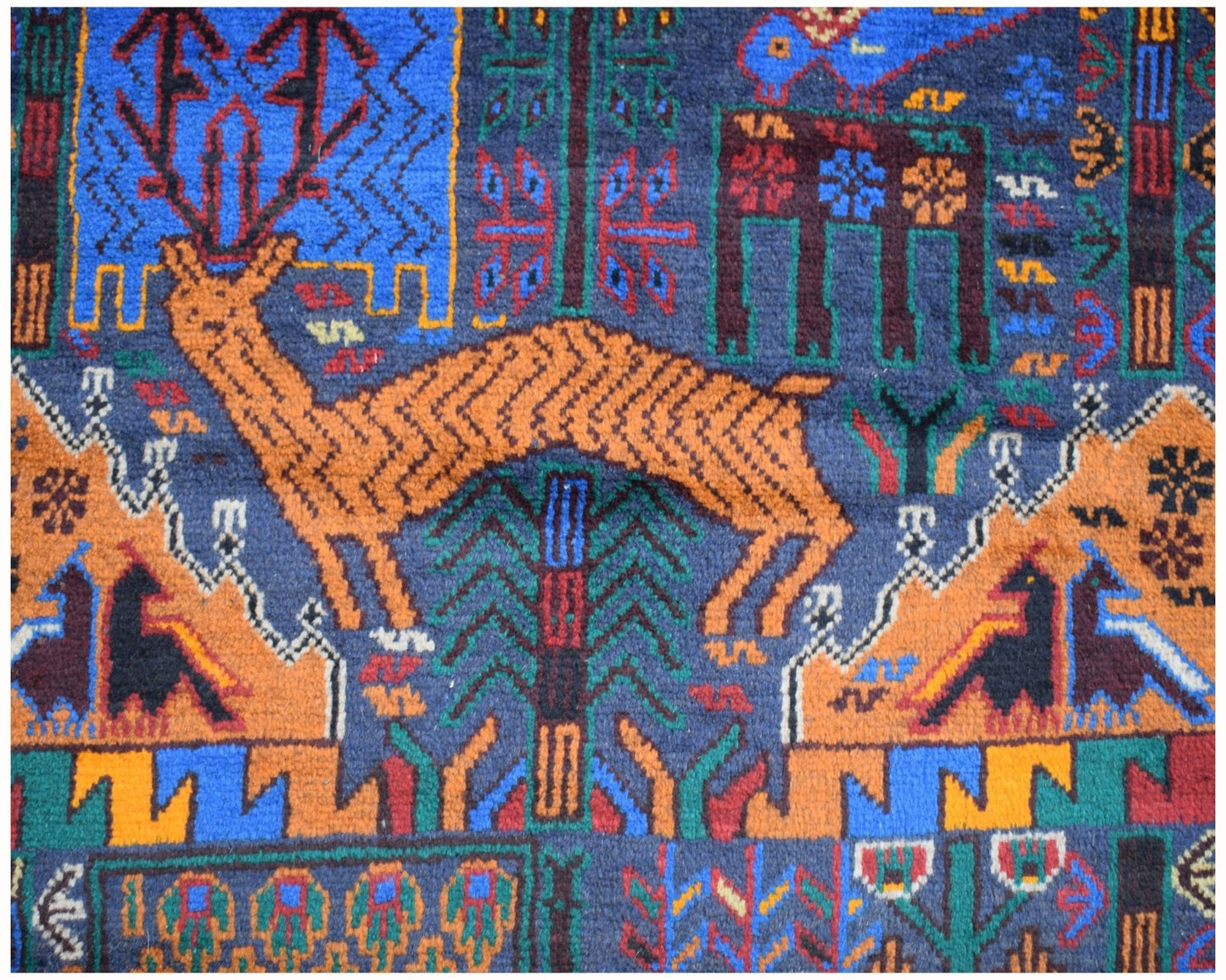 Handmade Afghan wool runner rug featuring a colorful hunting scene with deer and stylized trees.