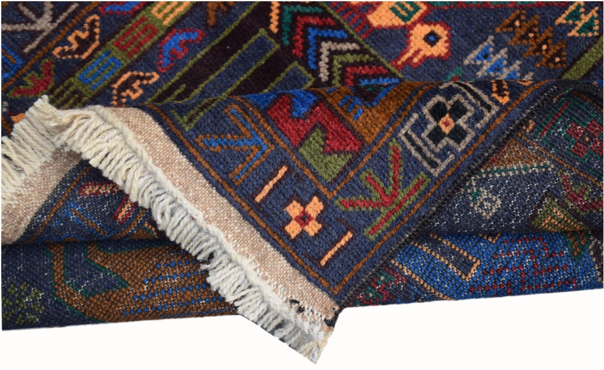 A handmade Afghan wool runner featuring a dark blue background with intricate geometric patterns.