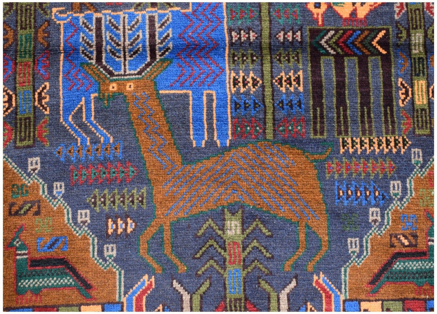 Handmade Afghan wool runner rug featuring a detailed hunting scene with deer and geometric motifs.