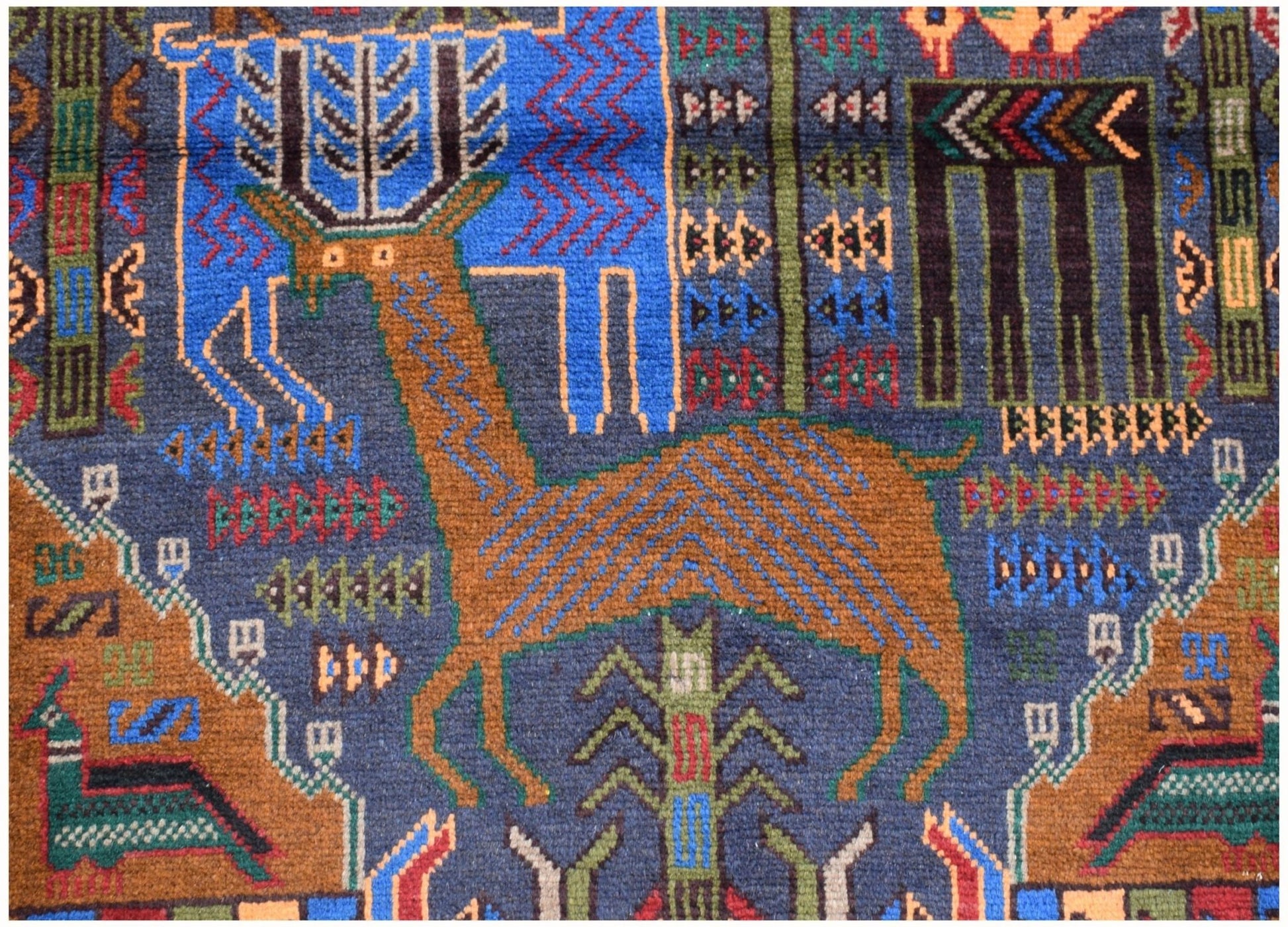 Handmade Afghan wool runner rug featuring a detailed hunting scene with deer and geometric motifs.