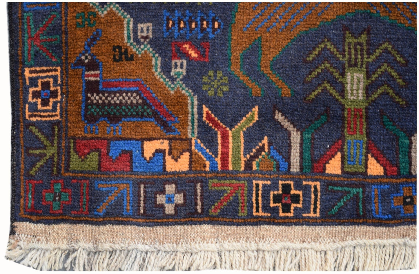 A handmade Afghan wool runner featuring a colorful hunting scene with geometric animal motifs.