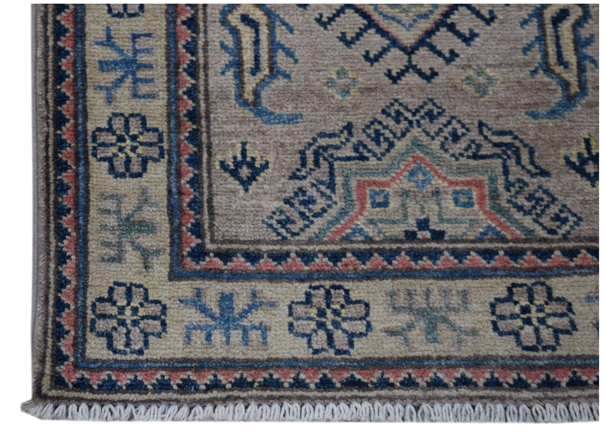 A handmade Afghan Kazakh runner featuring traditional geometric motifs in blue, red, and tan wool.