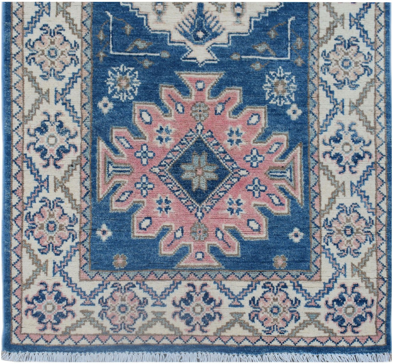 Handmade Afghan Kazakh runner featuring a pink central medallion on a blue field with cream borders.