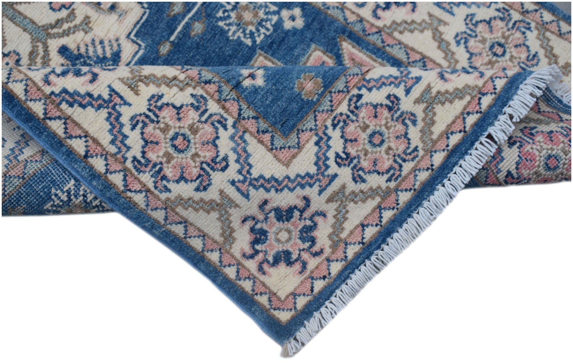 A handmade Afghan Kazakh runner featuring traditional blue, pink, and cream geometric patterns.