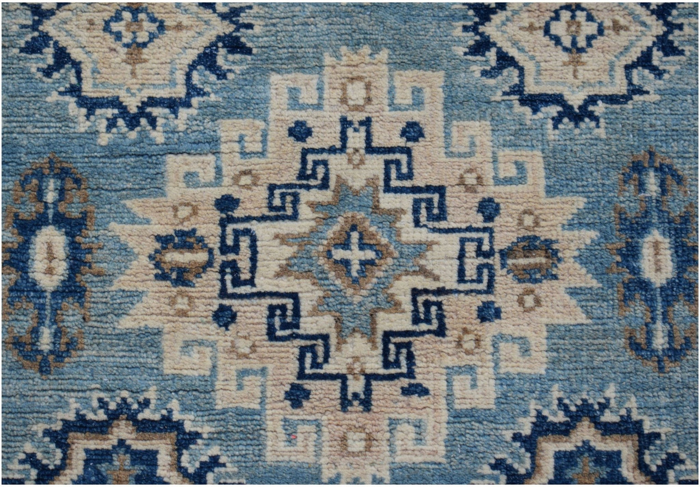 Handmade Afghan Kazakh runner rug featuring a geometric medallion pattern in blue and beige wool.