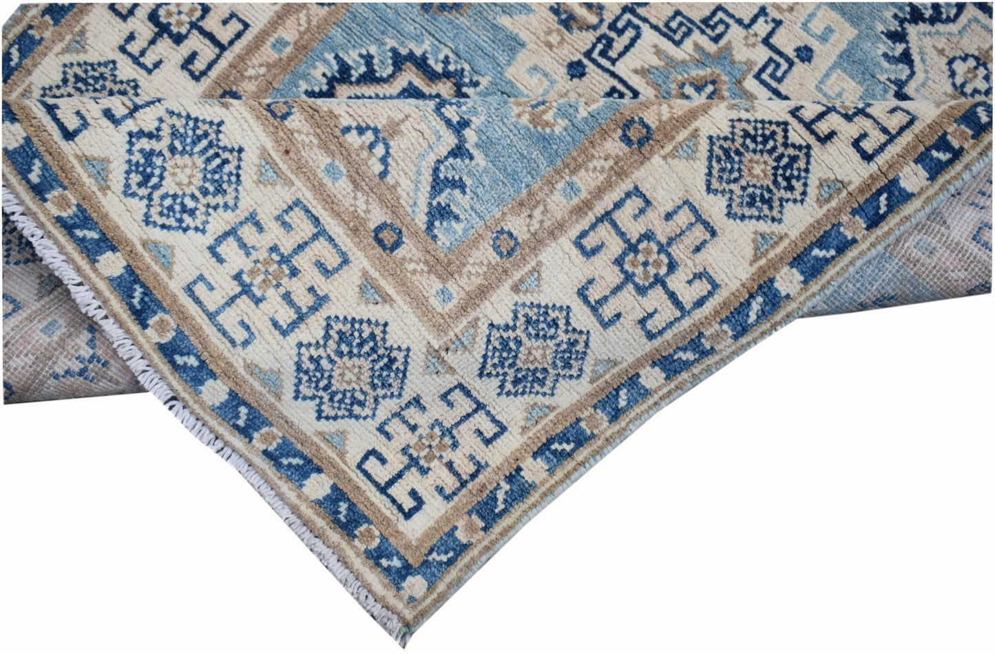 An Afghan Kazakh runner rug featuring a geometric pattern in shades of blue, beige, and grey.