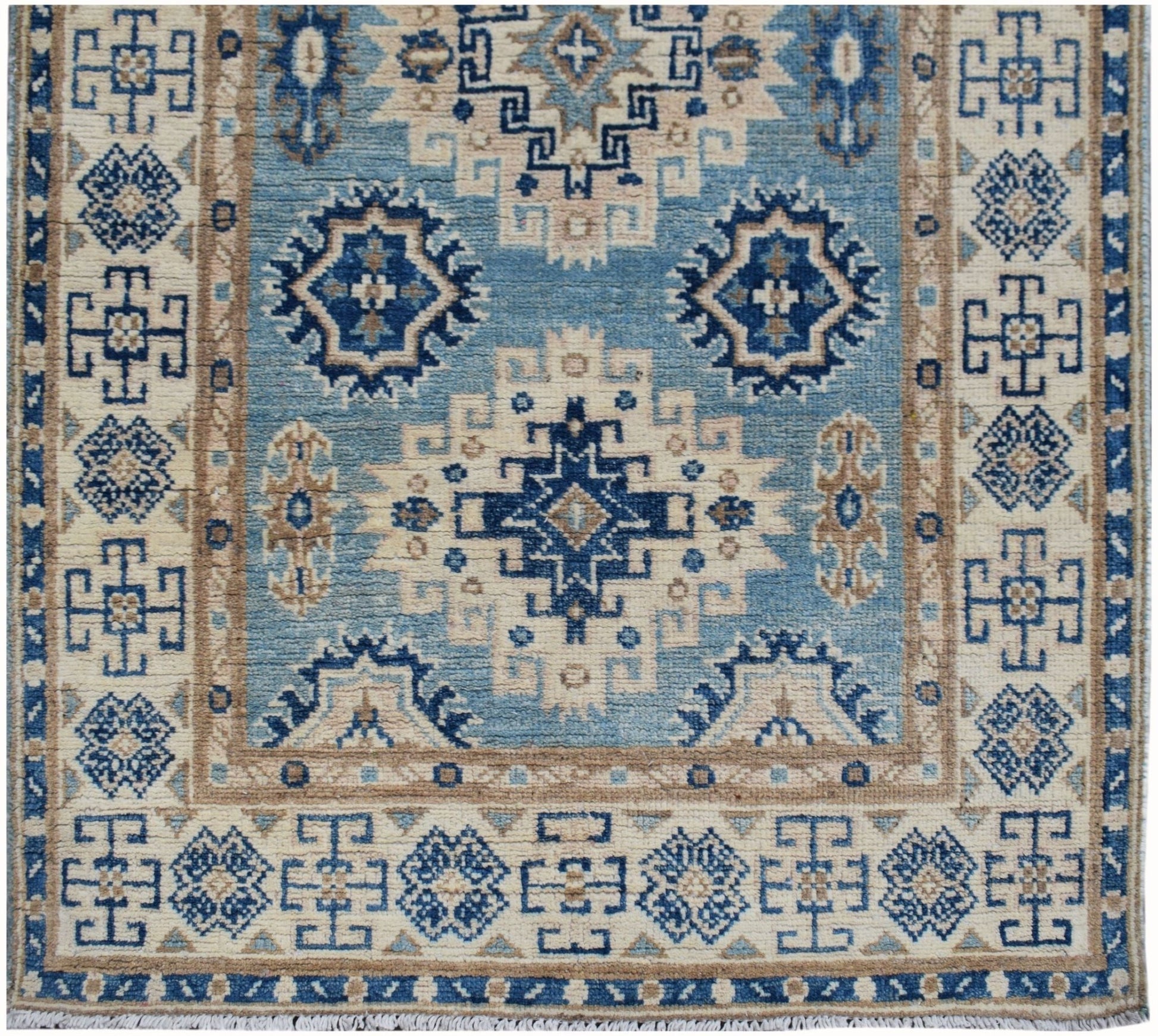 Handmade Afghan Kazakh runner featuring a geometric pattern in shades of blue, beige, and brown.