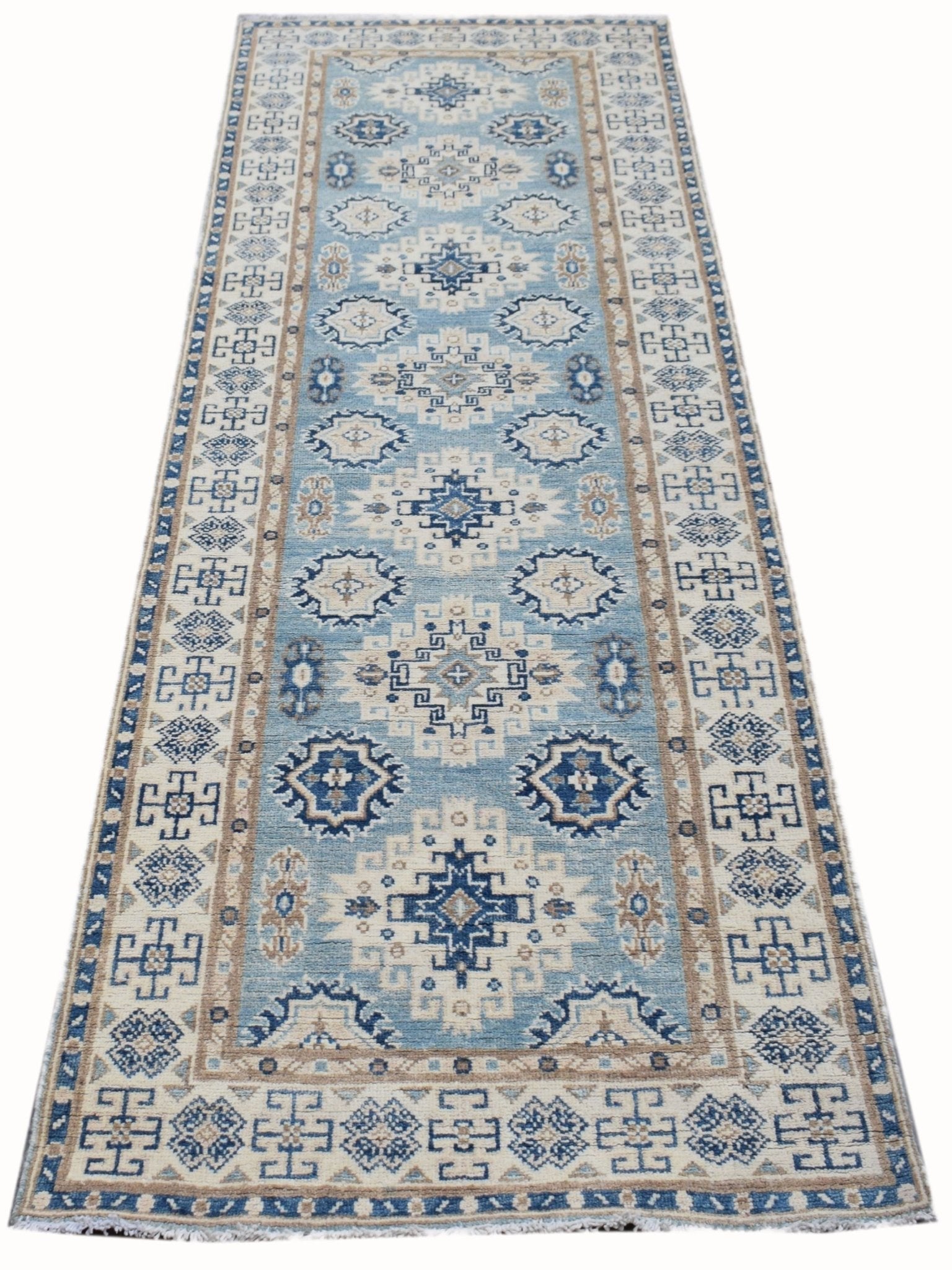 A handmade Afghan Kazakh runner rug featuring a geometric pattern in shades of blue and beige.