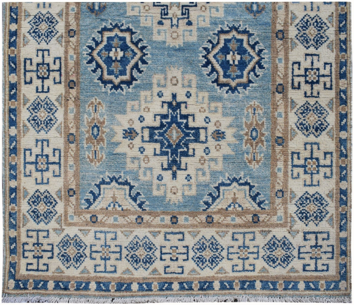 Handmade Afghan Kazakh runner rug featuring geometric blue and beige tribal patterns.