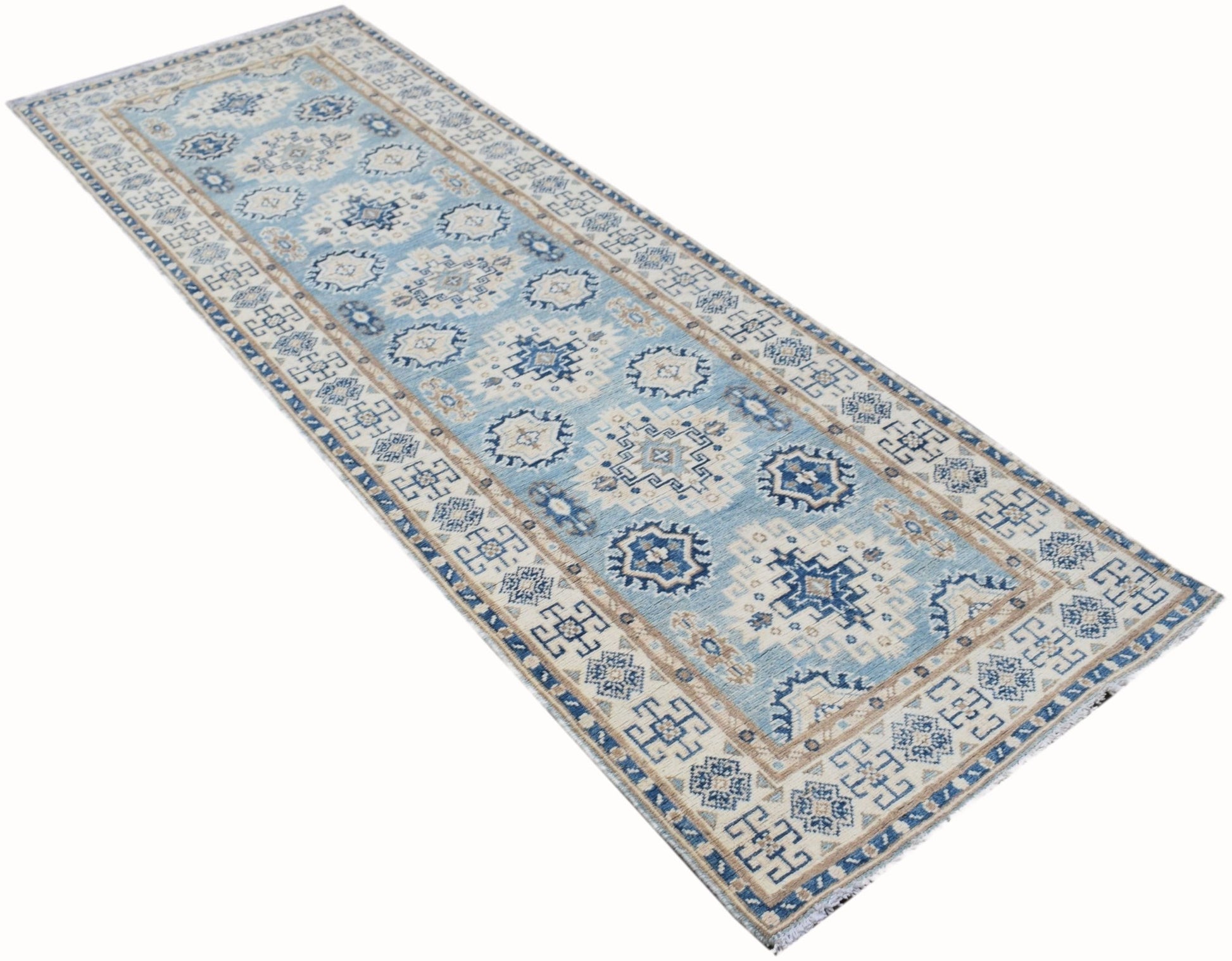 An Afghan Kazakh runner rug featuring a geometric pattern in shades of blue, beige, and grey.