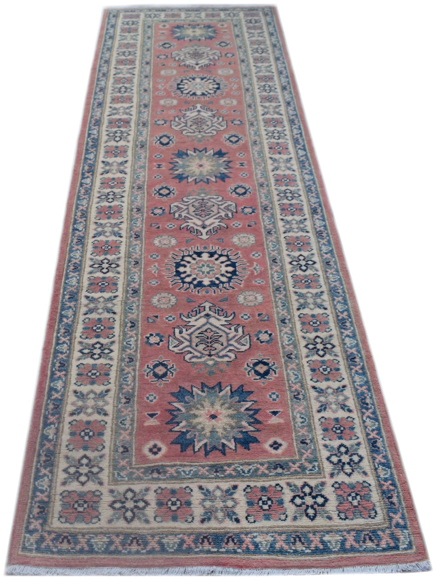 A handmade Afghan Kazakh runner rug featuring traditional geometric motifs in pink and blue.