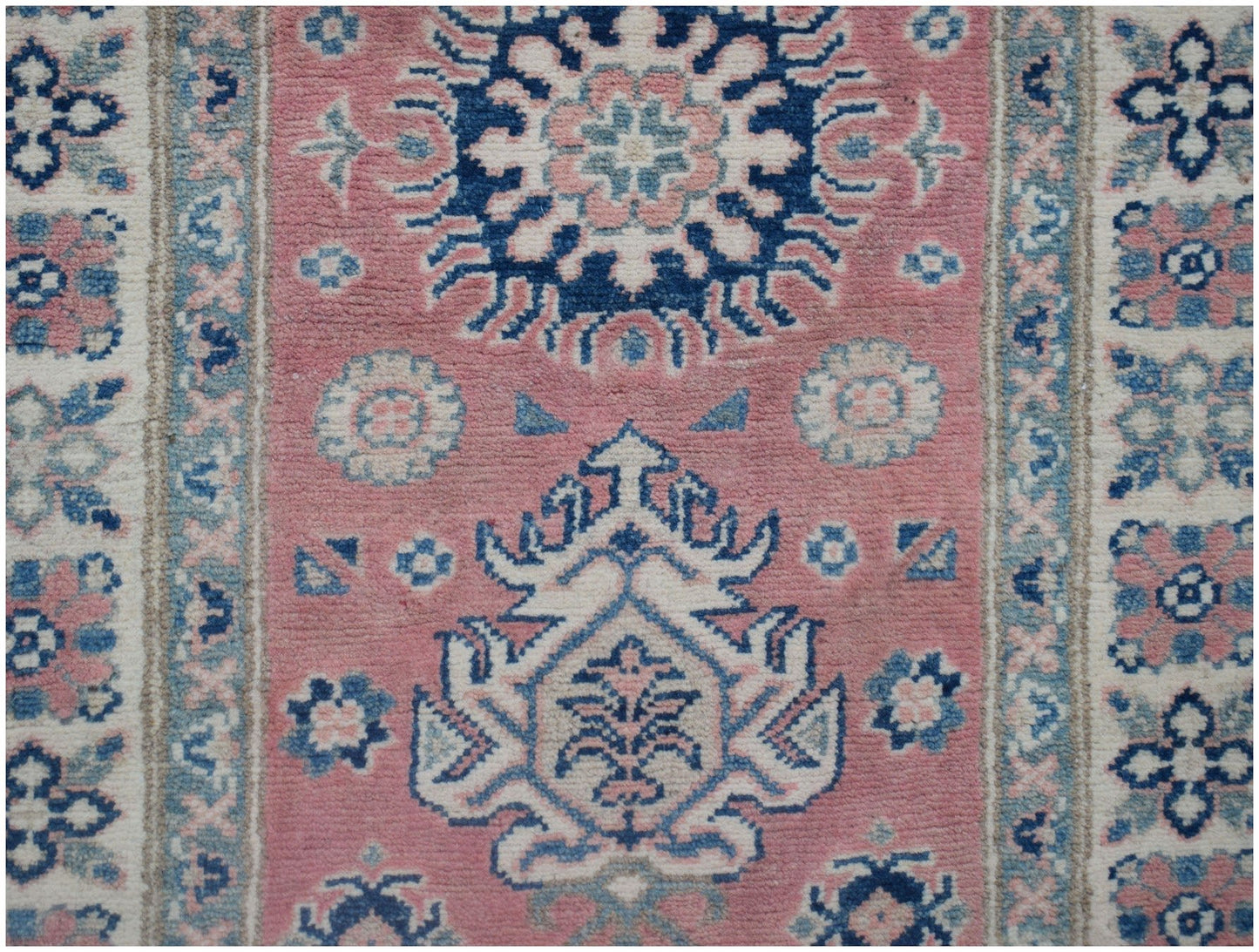 Handmade Afghan Kazakh runner rug featuring traditional geometric motifs in pink, blue, and cream.