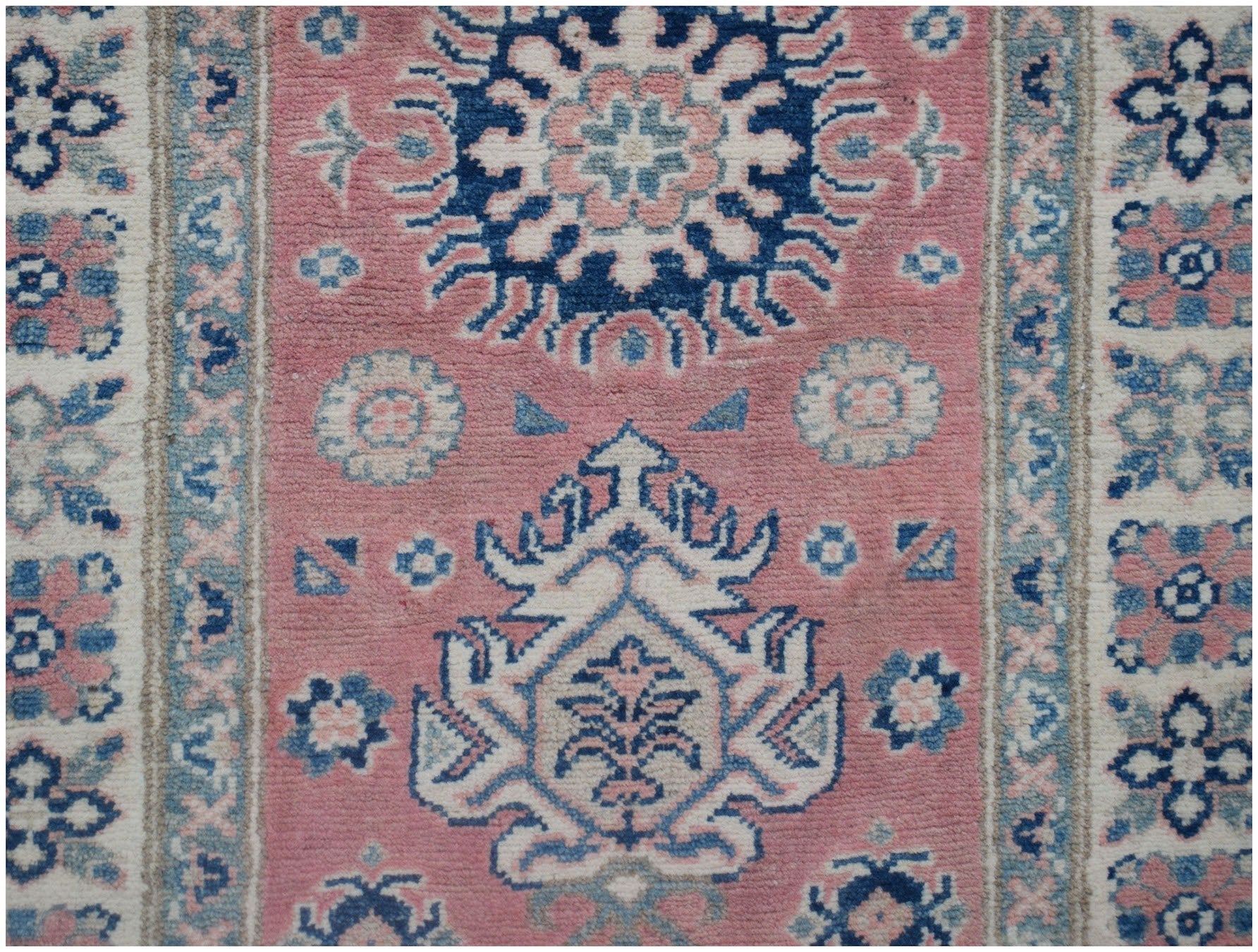 Handmade Afghan Kazakh runner rug featuring traditional geometric motifs in pink, blue, and cream.