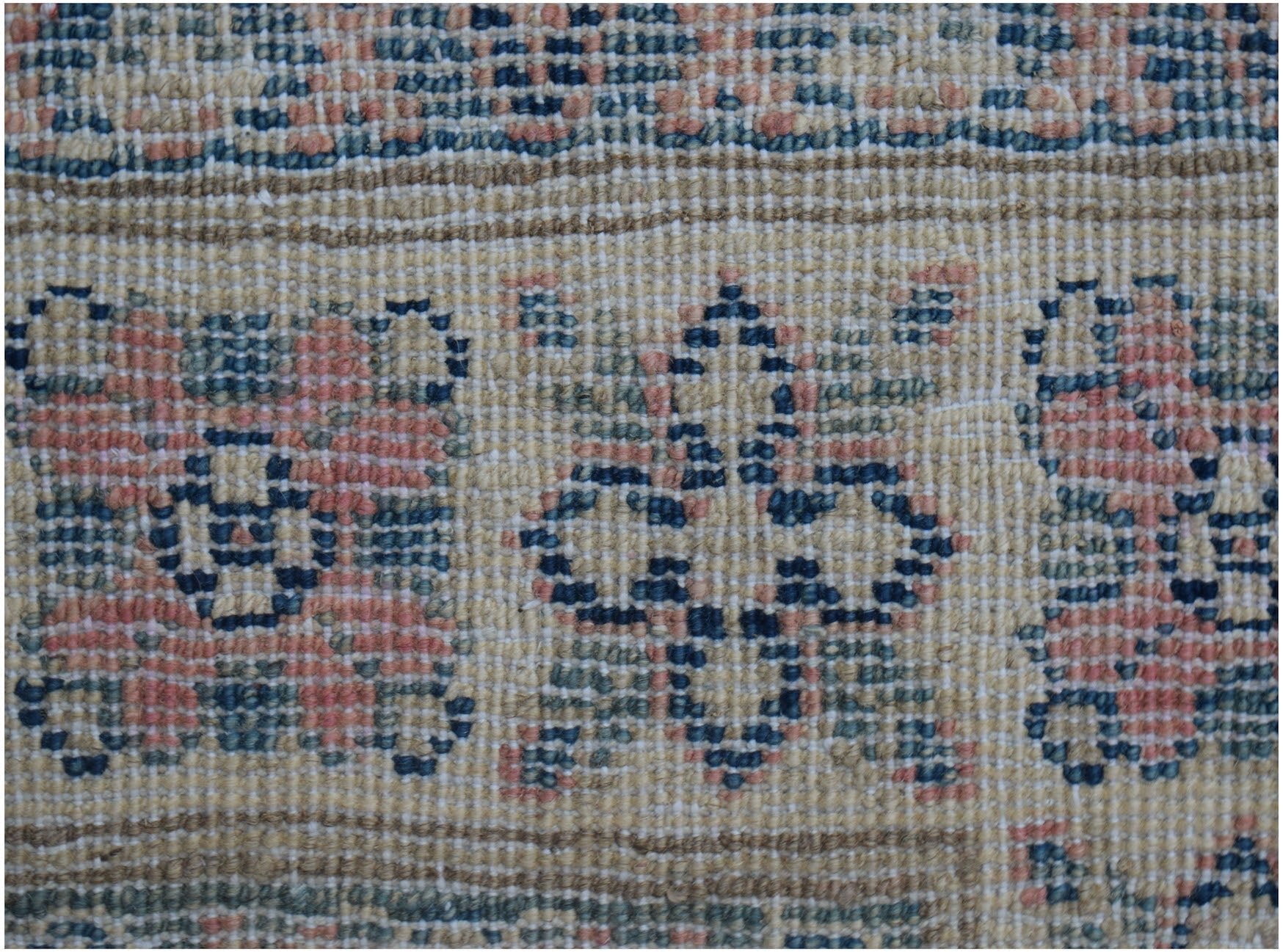 A close-up of a handmade Afghan Kazakh runner featuring traditional geometric motifs in wool.