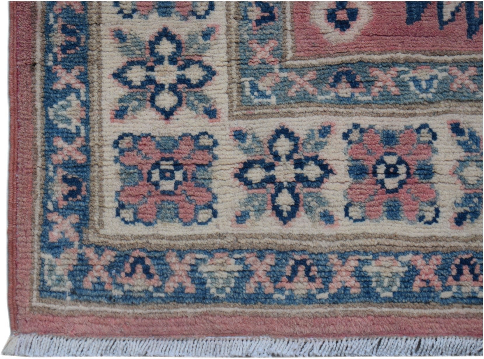 A handmade Afghan Kazakh runner featuring traditional floral motifs in pink, blue, and cream wool.