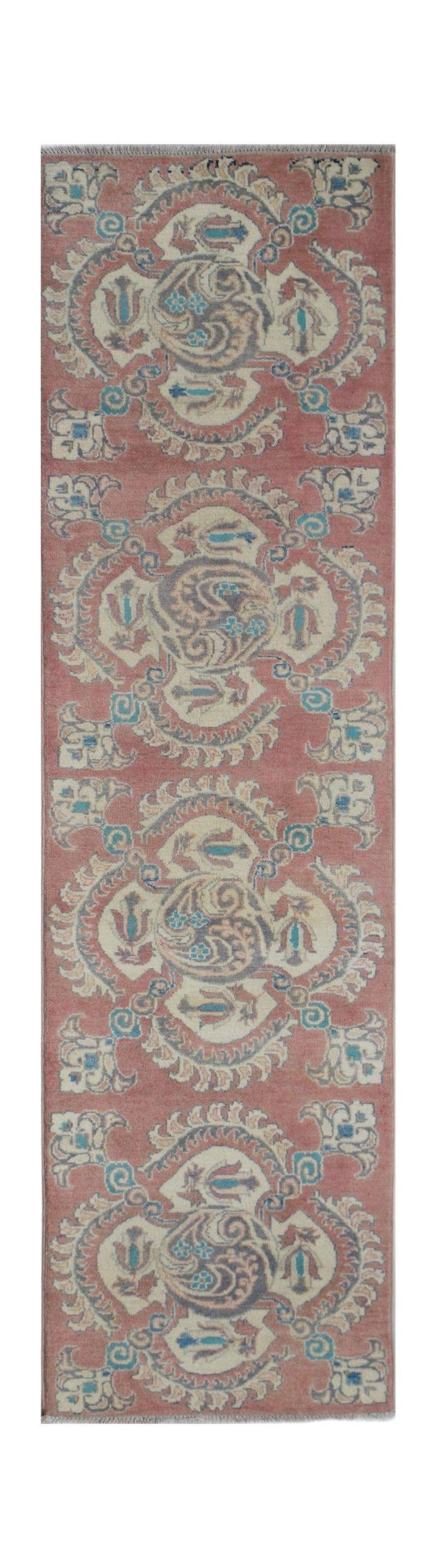 Handmade Afghan Kazakh runner rug featuring traditional floral motifs in pink, blue, and cream.