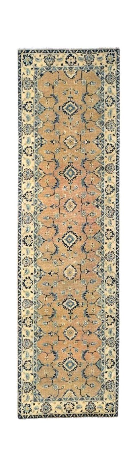 Handmade Afghan Kazakh runner rug featuring a beige field with blue and grey geometric motifs.