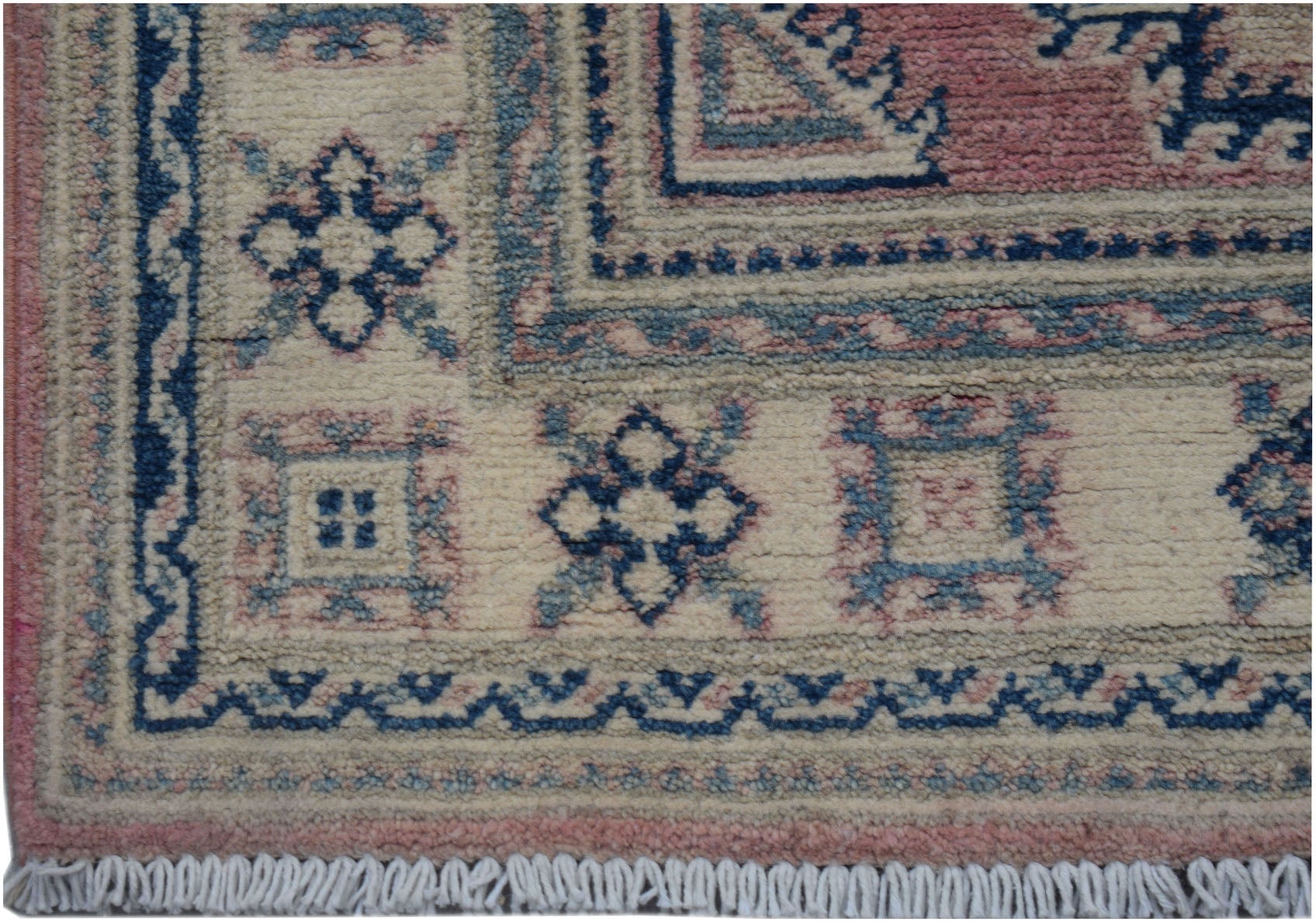 A handmade Afghan Kazakh runner featuring traditional geometric motifs in blue, pink, and cream.