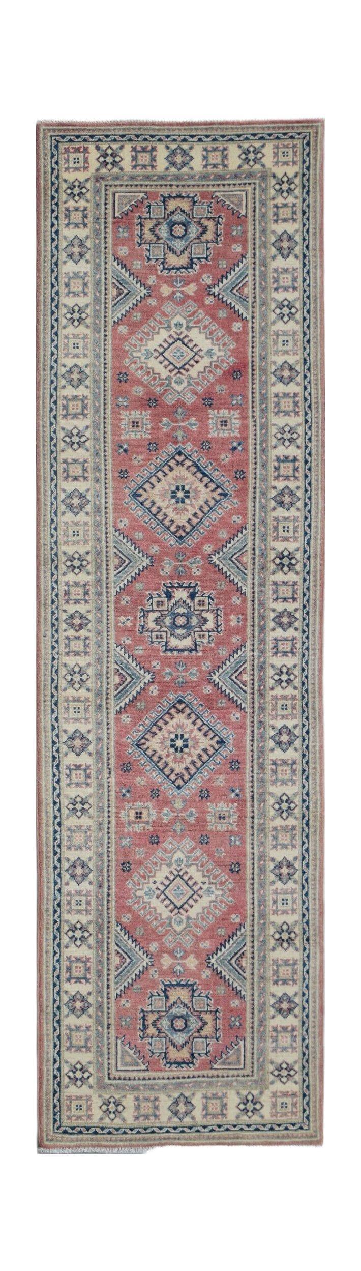 A handmade Afghan Kazakh runner rug featuring traditional geometric motifs in red, blue, and cream.