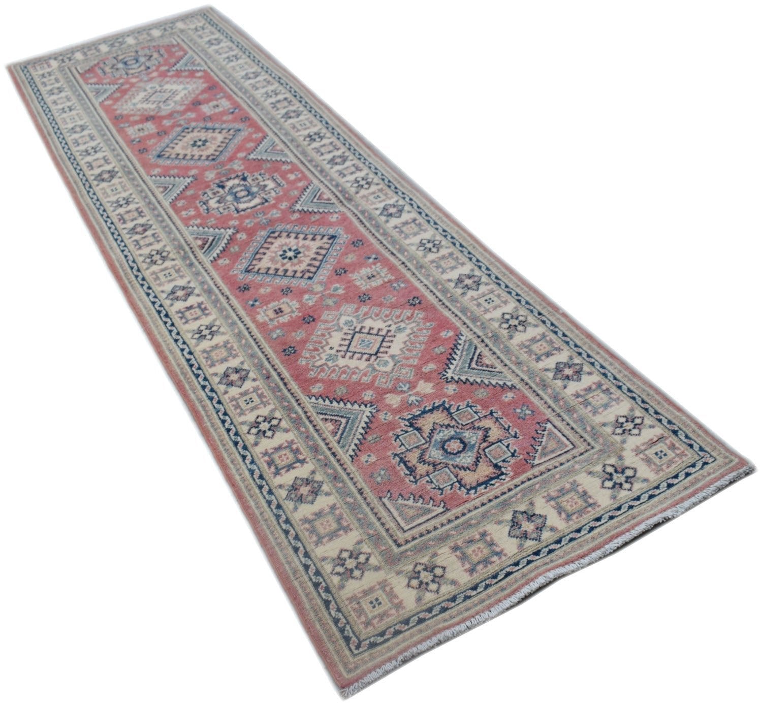 A handmade Afghan Kazakh runner rug featuring traditional geometric motifs in red and blue tones.