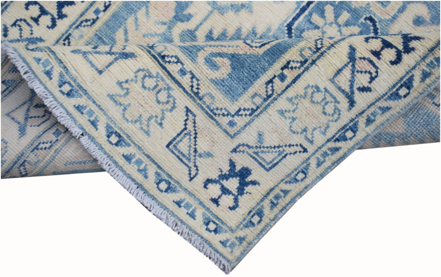 A handmade Afghan Kazakh runner rug featuring a blue and beige geometric pattern.