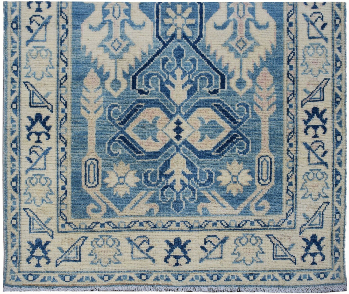 Handmade Afghan Kazakh runner rug featuring a geometric blue and beige pattern.