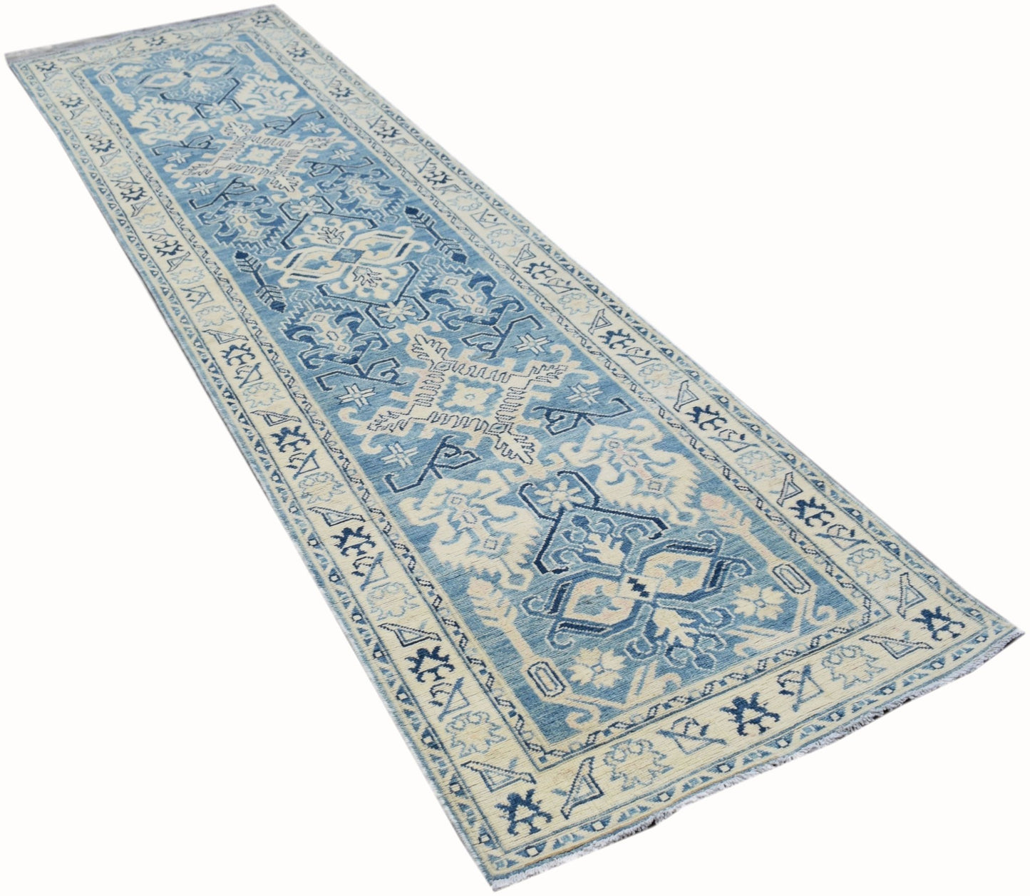 A handmade Afghan Kazakh runner rug featuring a geometric pattern in shades of blue and beige.