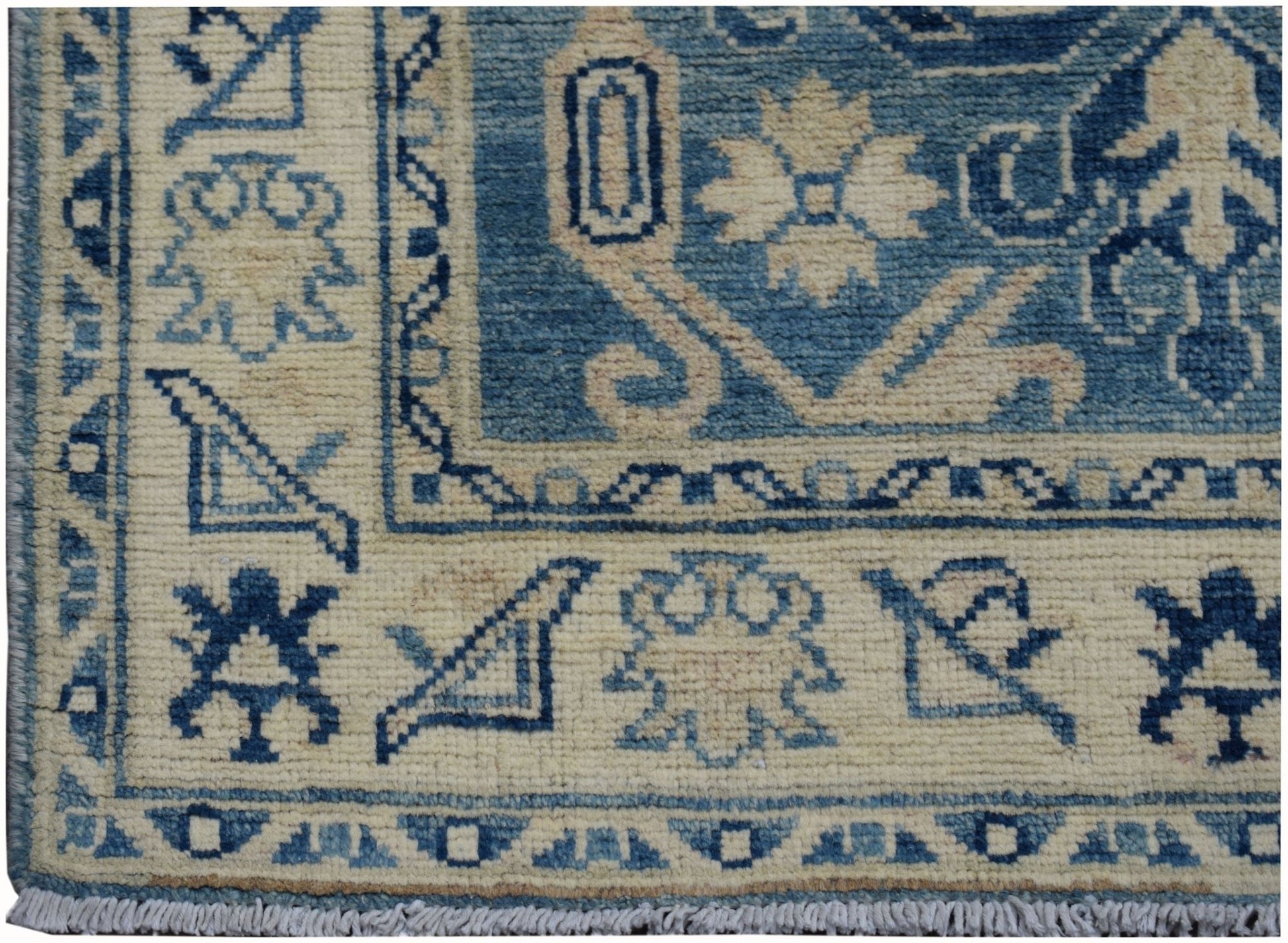 Handmade Afghan Kazakh runner rug featuring a blue and beige geometric pattern.