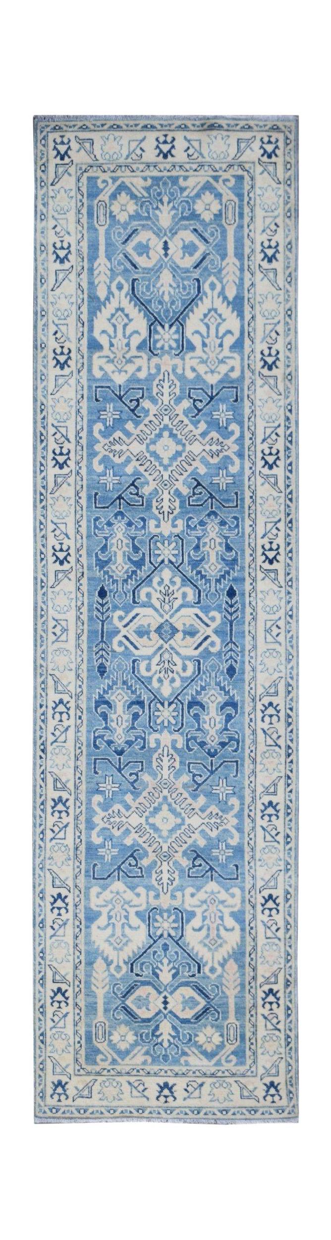 A handmade Afghan Kazakh runner rug featuring a traditional geometric pattern in shades of blue.