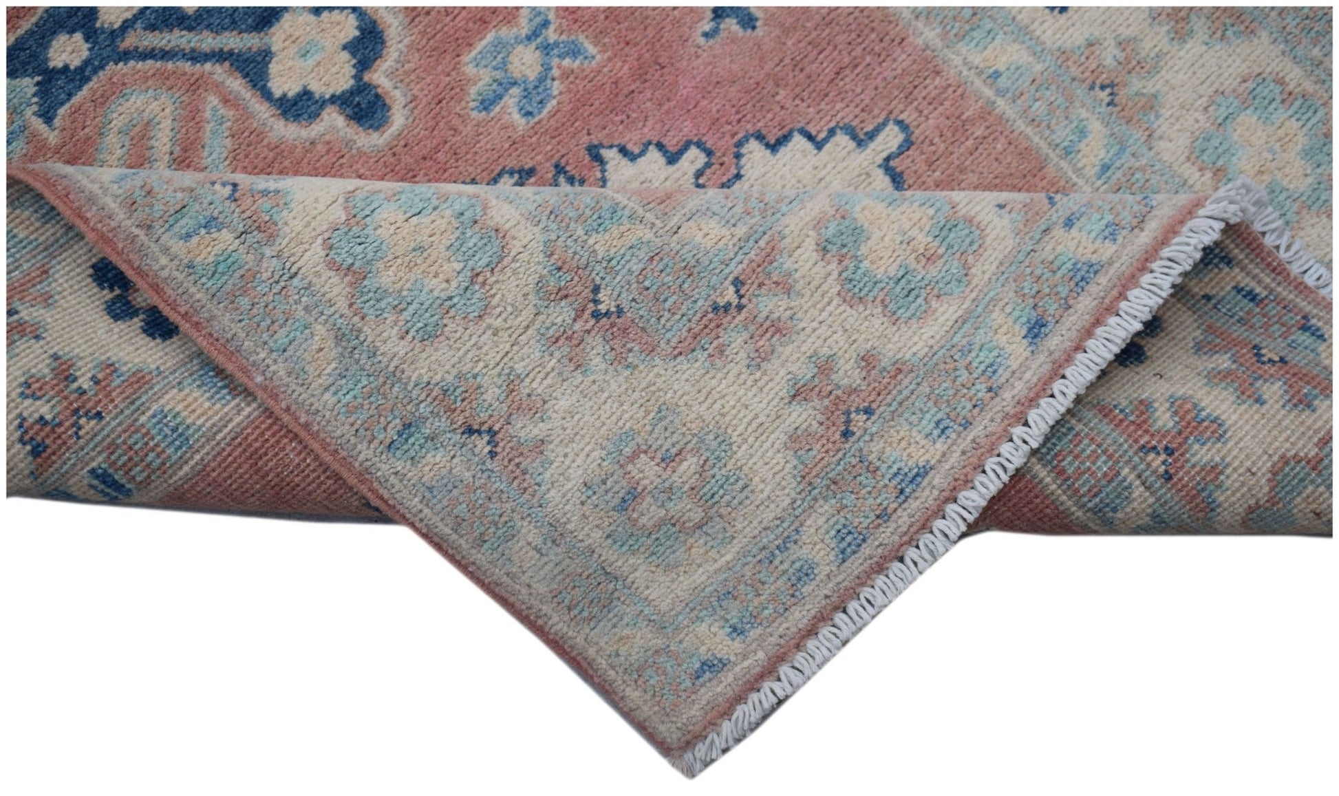 A handmade Afghan Kazakh runner featuring traditional floral motifs in pink, blue, and cream wool.