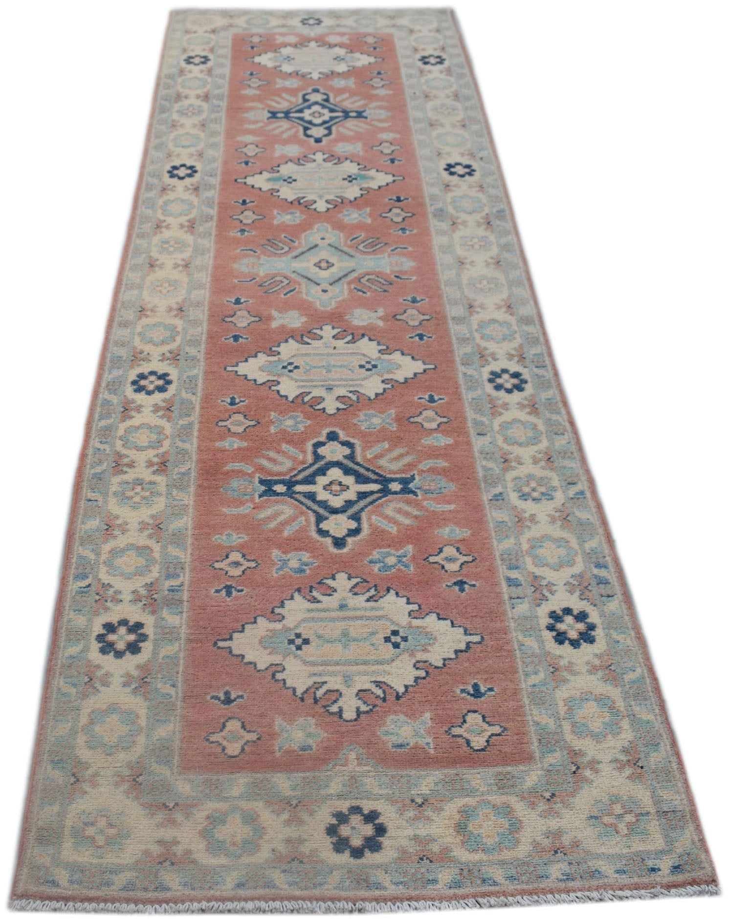 A handmade Afghan Kazakh runner rug featuring traditional geometric motifs in pink and blue tones.