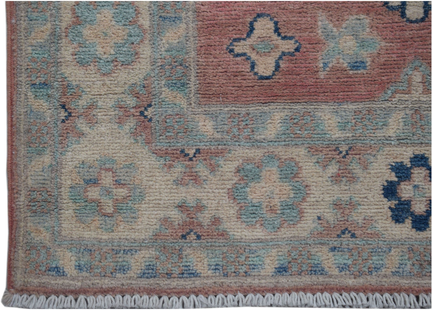 A handmade Afghan Kazakh runner featuring traditional floral motifs in blue, pink, and cream wool.