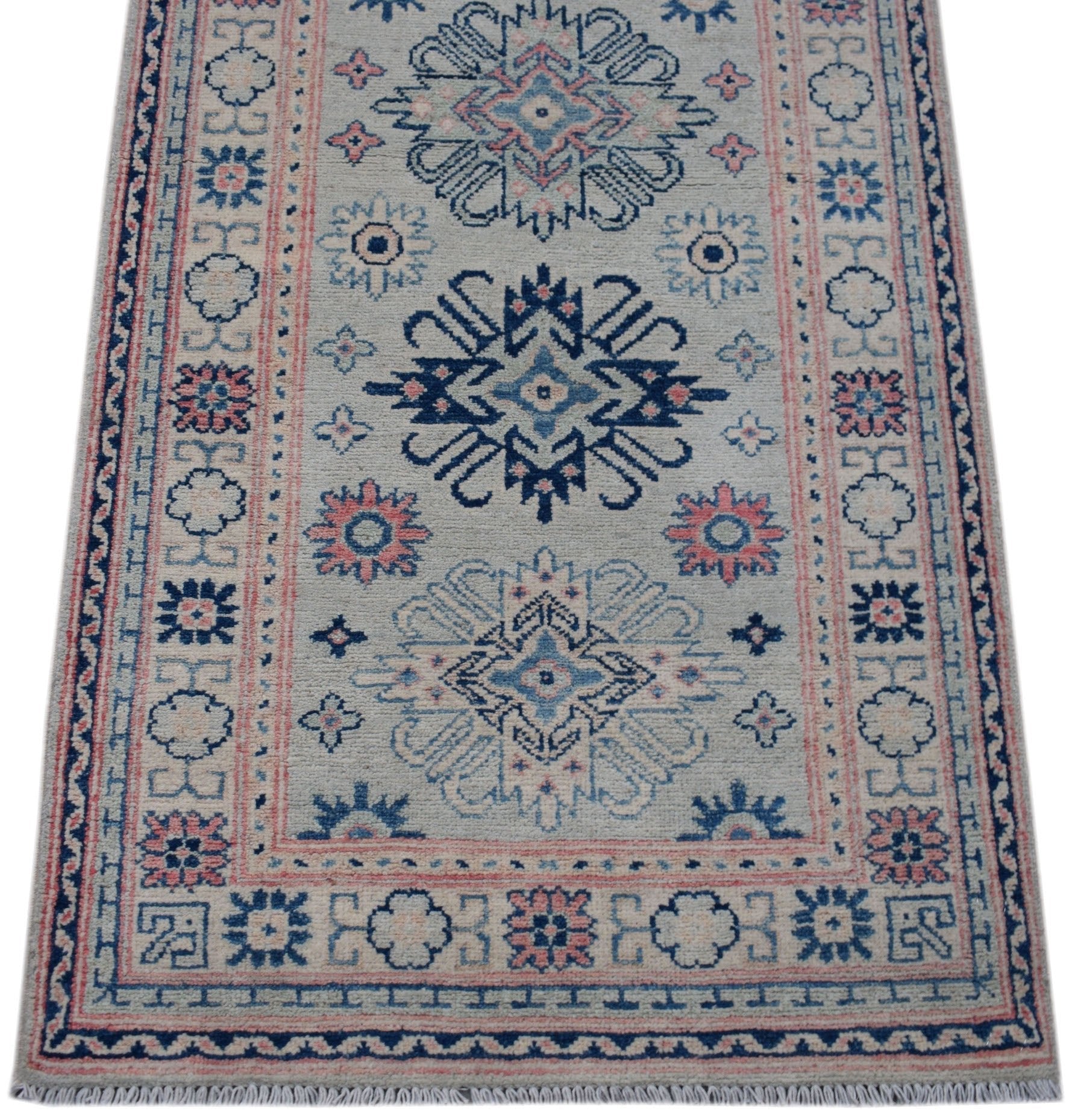Handmade Afghan Kazakh runner rug featuring traditional geometric motifs in blue and pink.