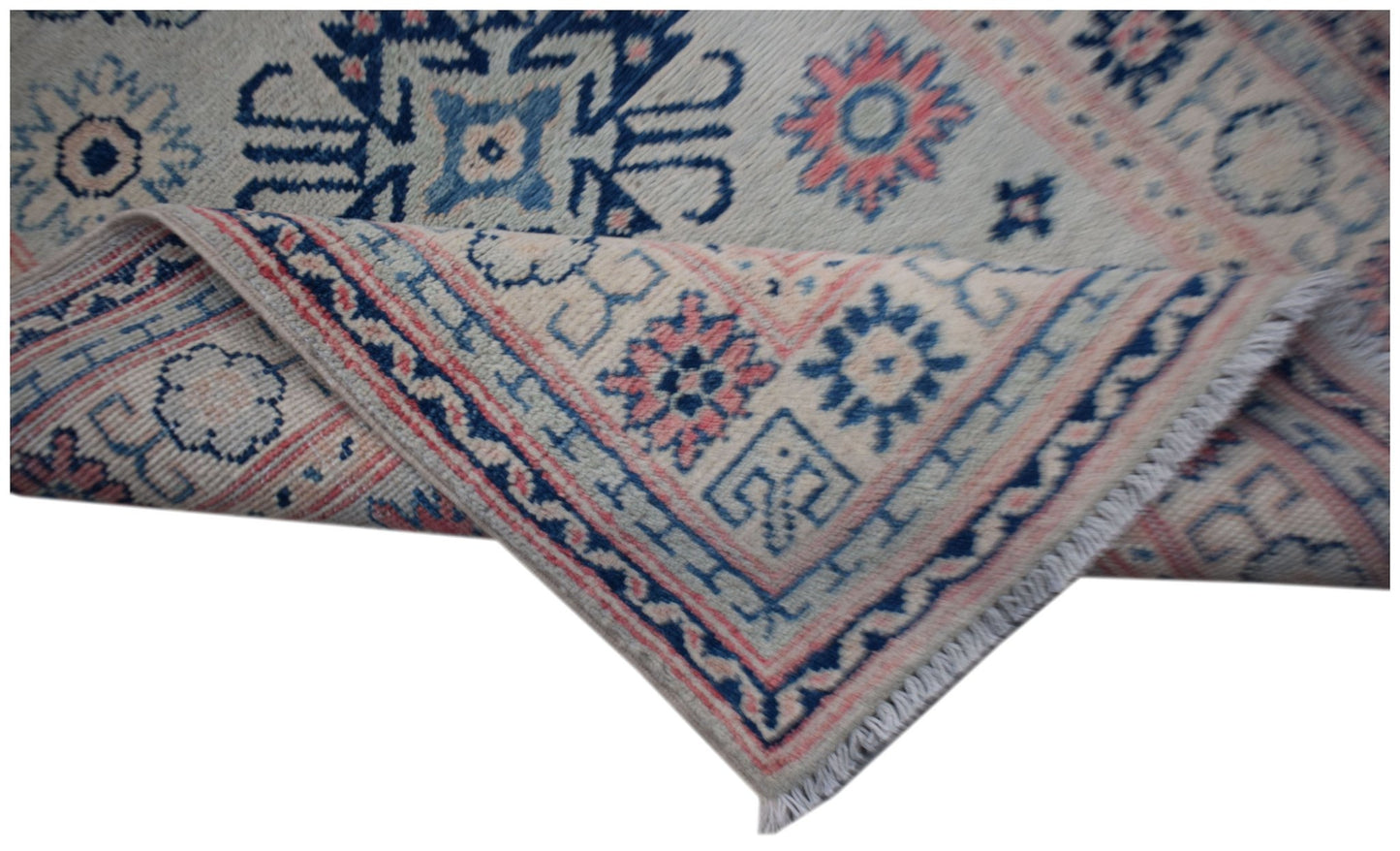 An Afghan Kazakh runner featuring traditional blue and pink geometric motifs on a cream background.