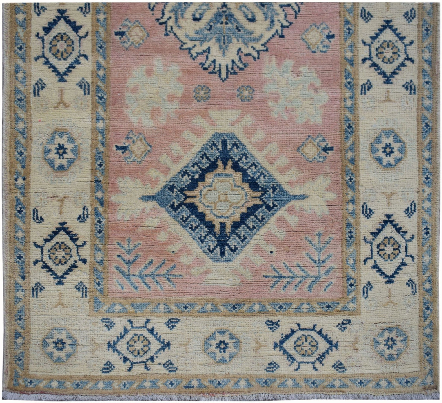 Handmade Afghan Kazakh runner featuring a central blue diamond motif on a soft pink field.