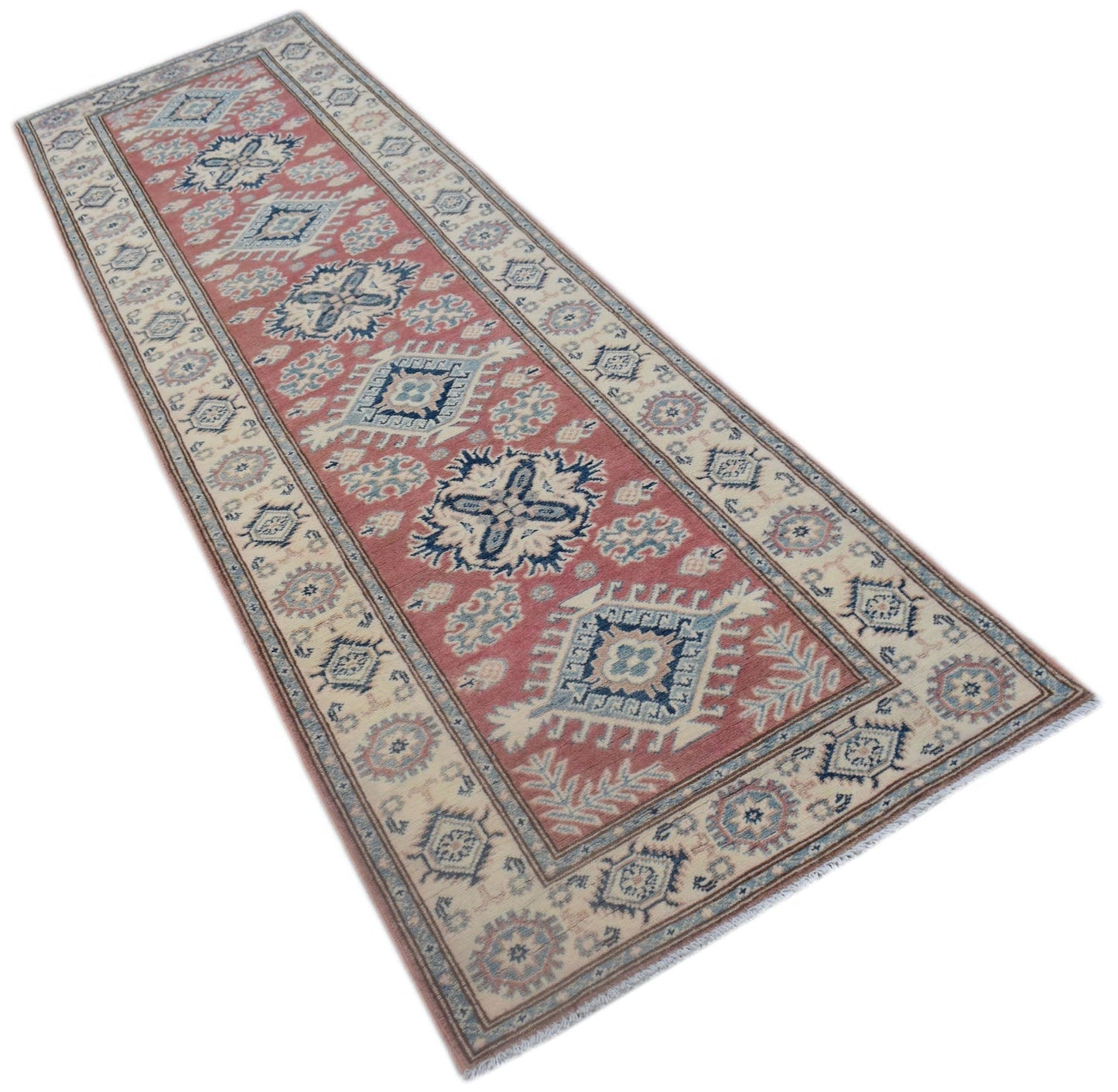 A handmade Afghan Kazakh runner rug featuring traditional geometric motifs in red, blue, and cream.