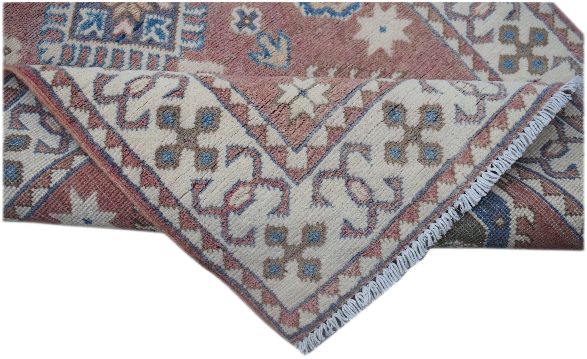 A handmade Afghan Kazakh runner featuring traditional geometric motifs in pink, blue, and cream.