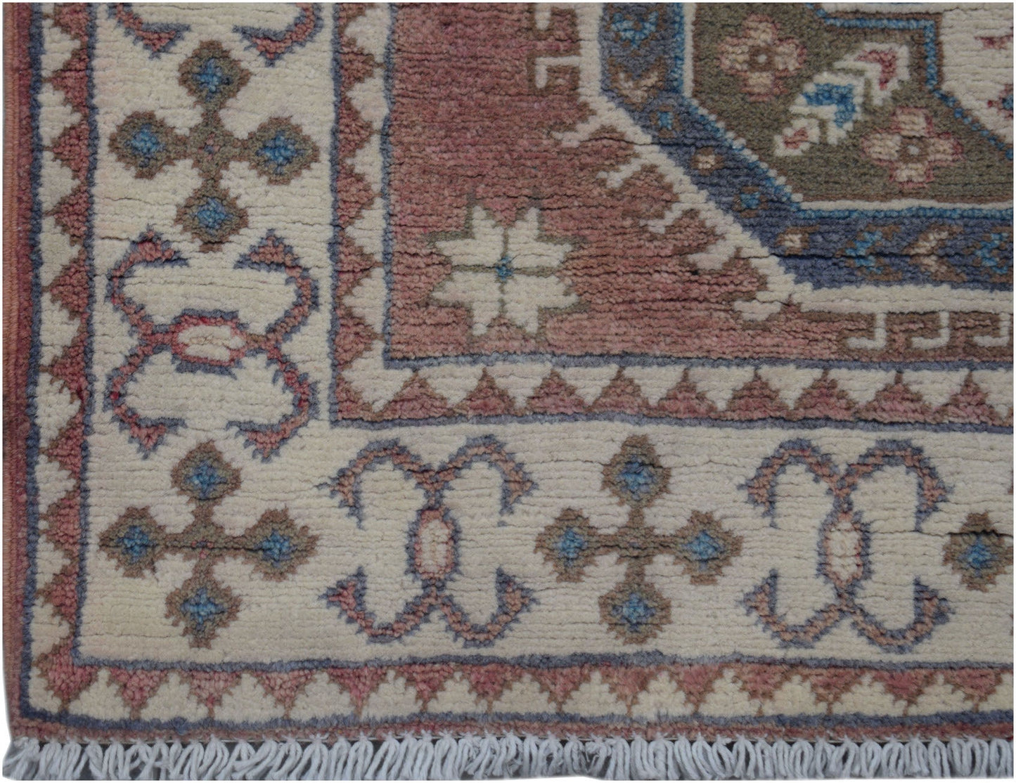 Handmade Afghan Kazakh runner featuring traditional geometric motifs in pink, blue, and cream.