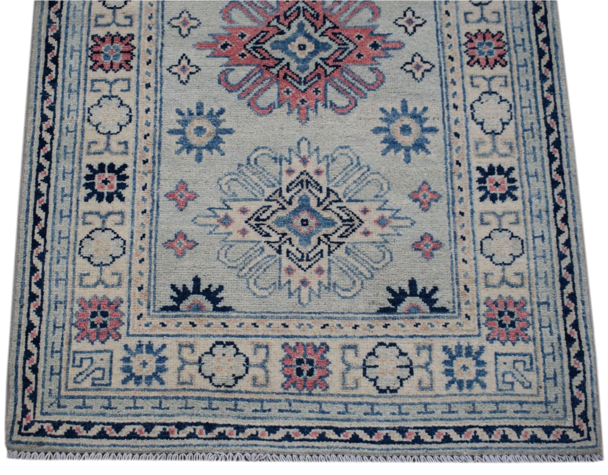 Handmade Afghan Kazakh runner rug featuring traditional geometric motifs in blue and pink.