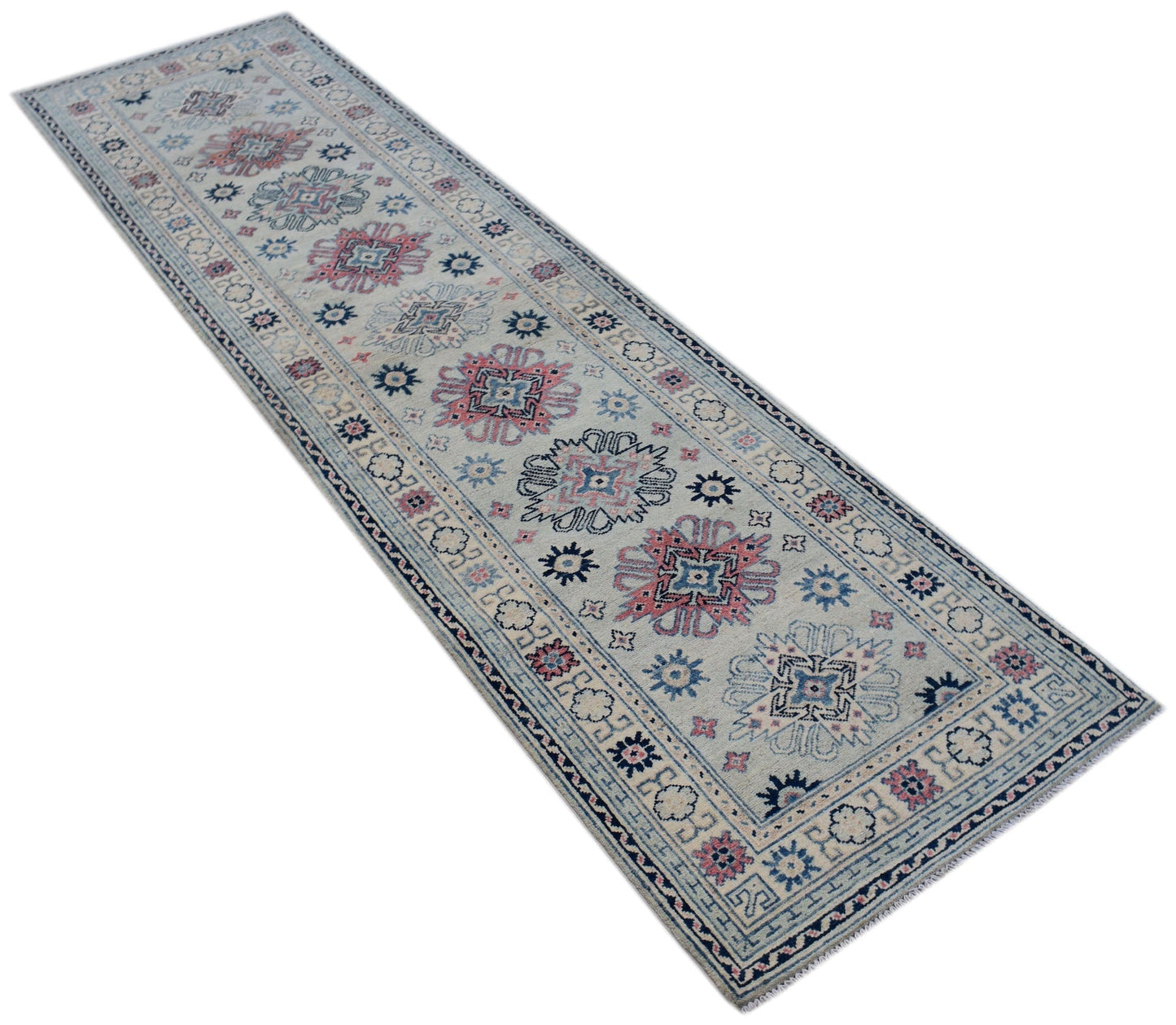 A handmade Afghan Kazakh runner rug featuring traditional geometric motifs in blue and pink wool.