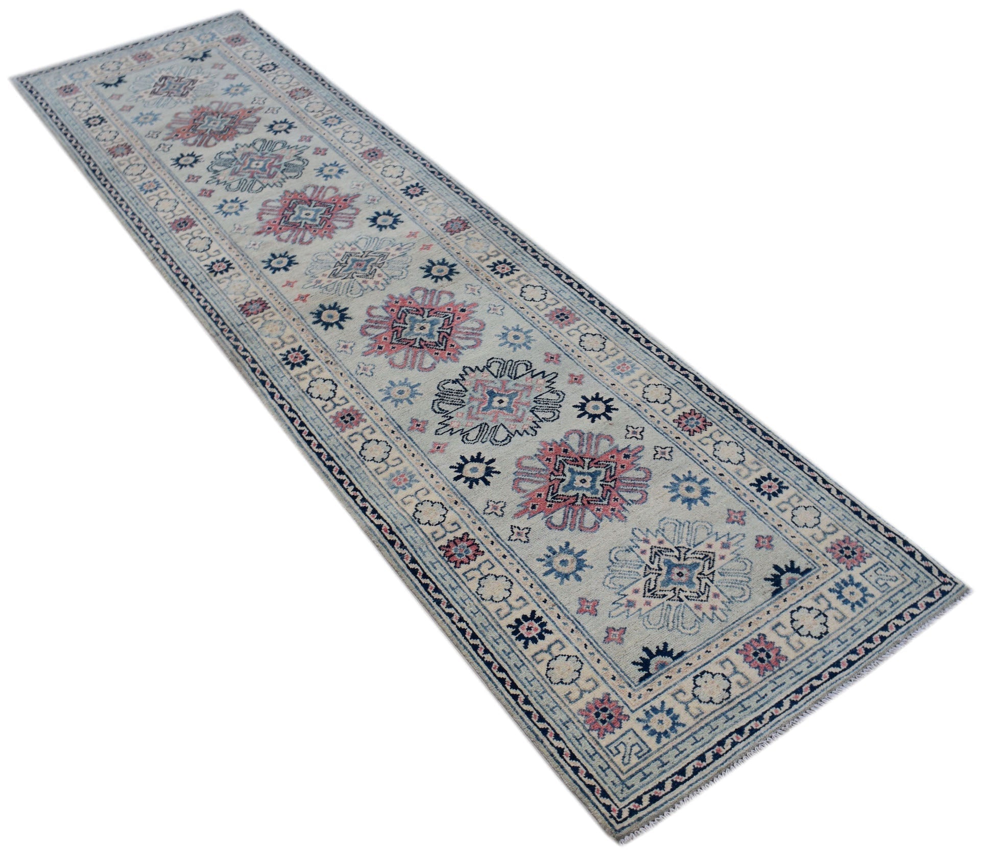 A handmade Afghan Kazakh runner rug featuring traditional geometric motifs in blue and pink wool.