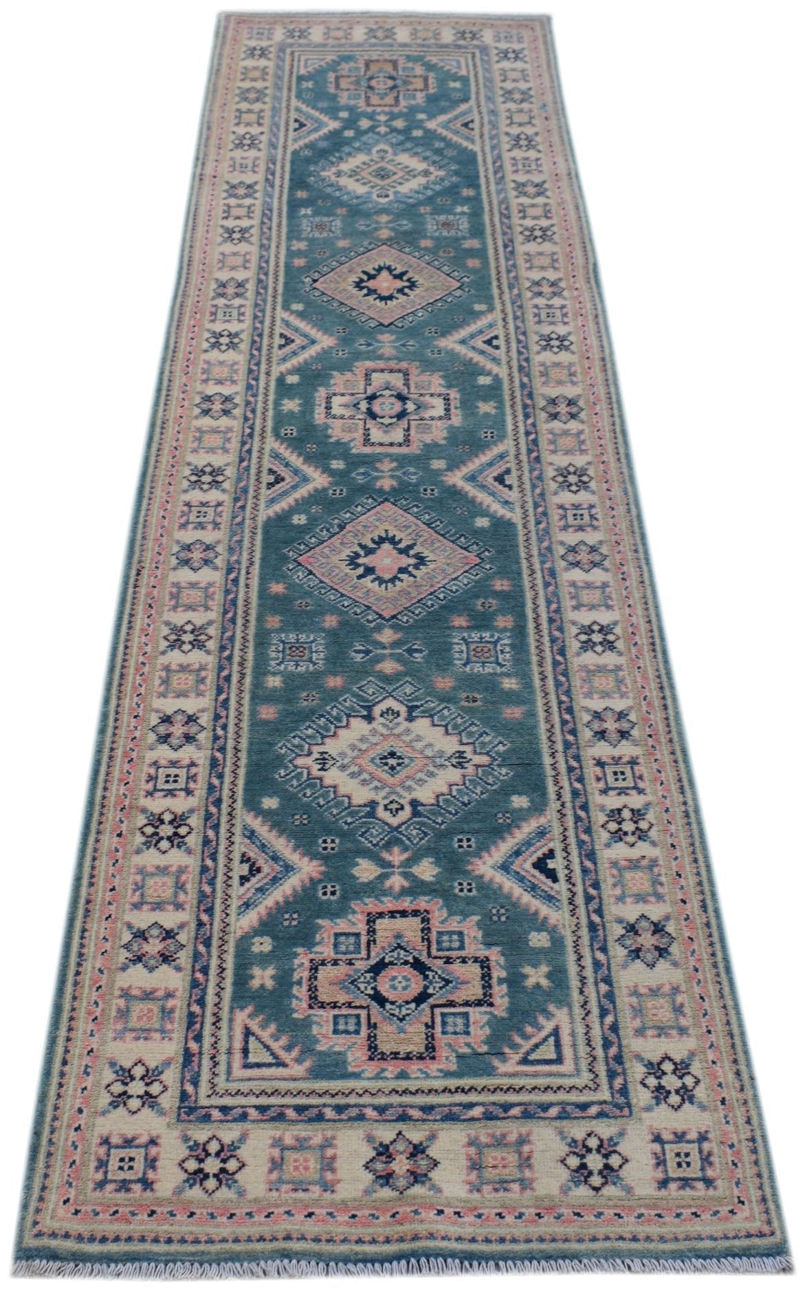 A handmade Afghan Kazakh runner rug featuring traditional geometric motifs in blue and pink tones.