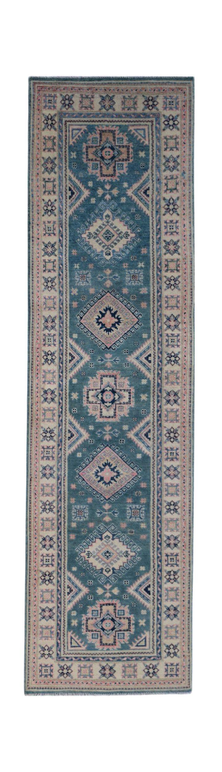 A handmade Afghan Kazakh runner rug featuring traditional geometric motifs in blue and pink tones.