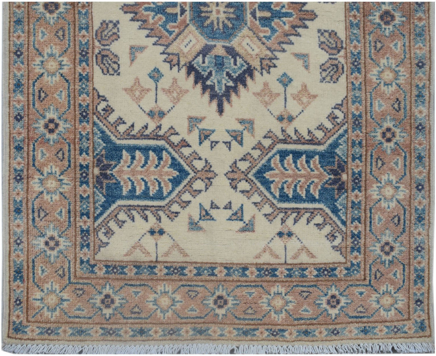 Handmade Afghan Kazakh runner featuring traditional geometric motifs in blue and tan on cream.