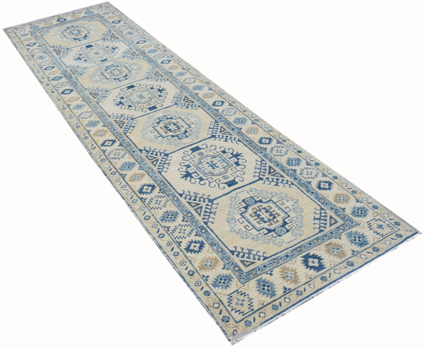 A handmade Afghan Kazakh runner rug featuring traditional blue and beige geometric patterns.