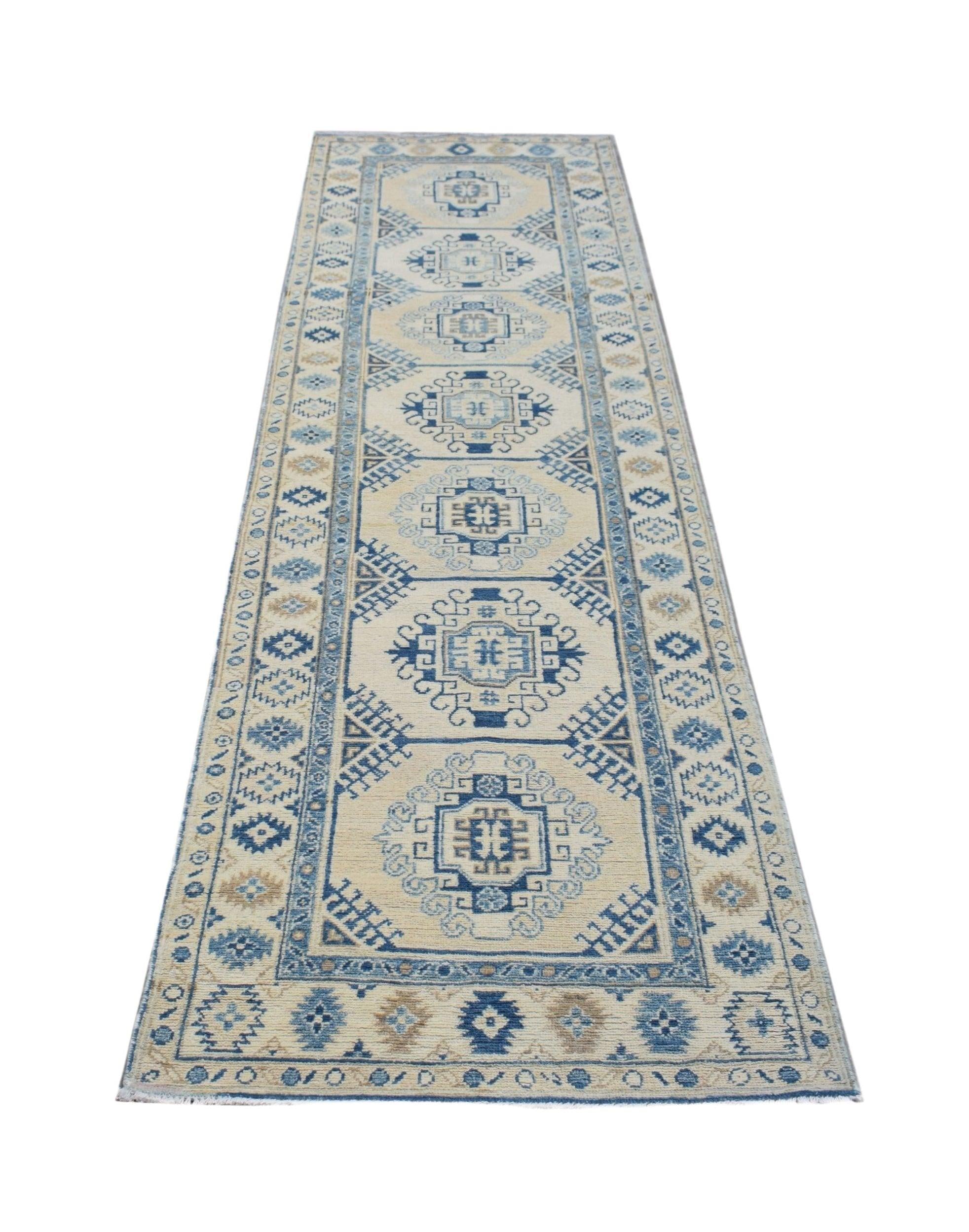 A handmade Afghan Kazakh runner rug featuring traditional geometric patterns in blue and cream.