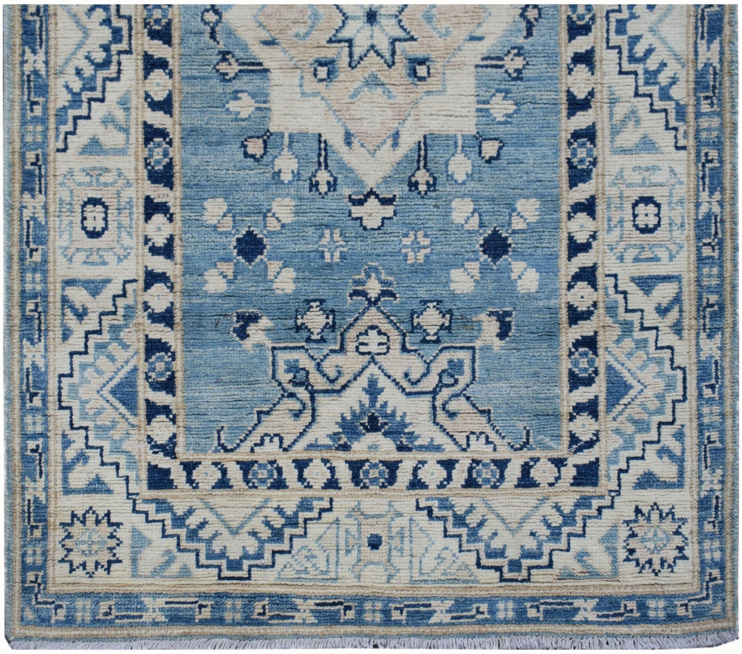 Handmade Afghan Kazakh runner rug featuring a geometric blue and beige pattern.