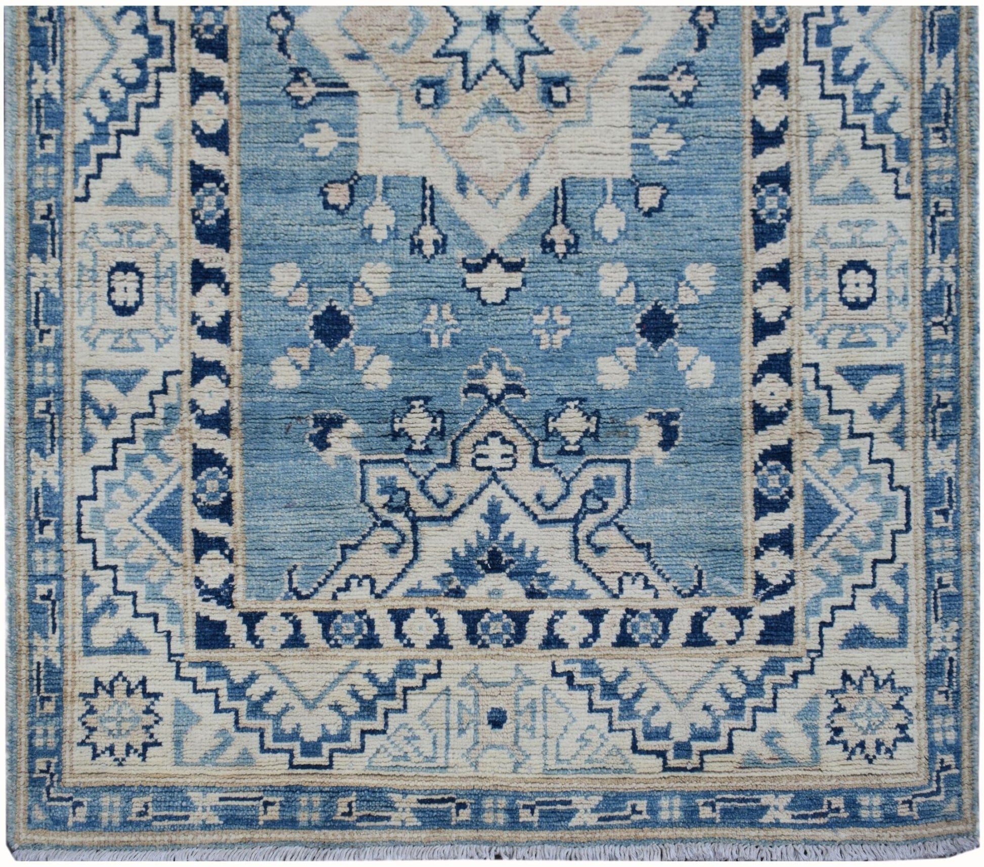 Handmade Afghan Kazakh runner rug featuring a geometric blue and beige pattern.