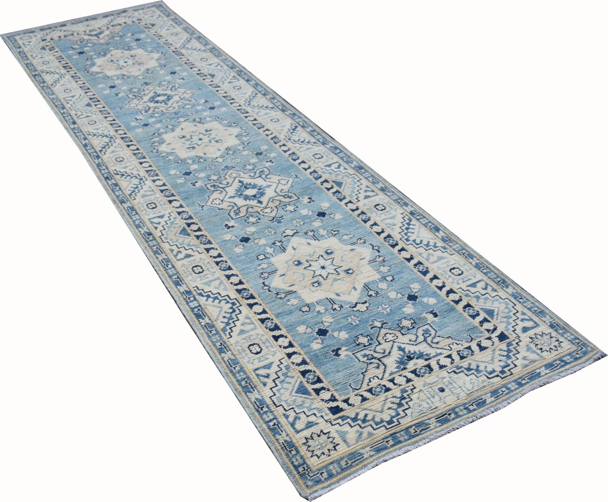 A handmade Afghan Kazakh runner rug featuring a blue and beige geometric medallion pattern.